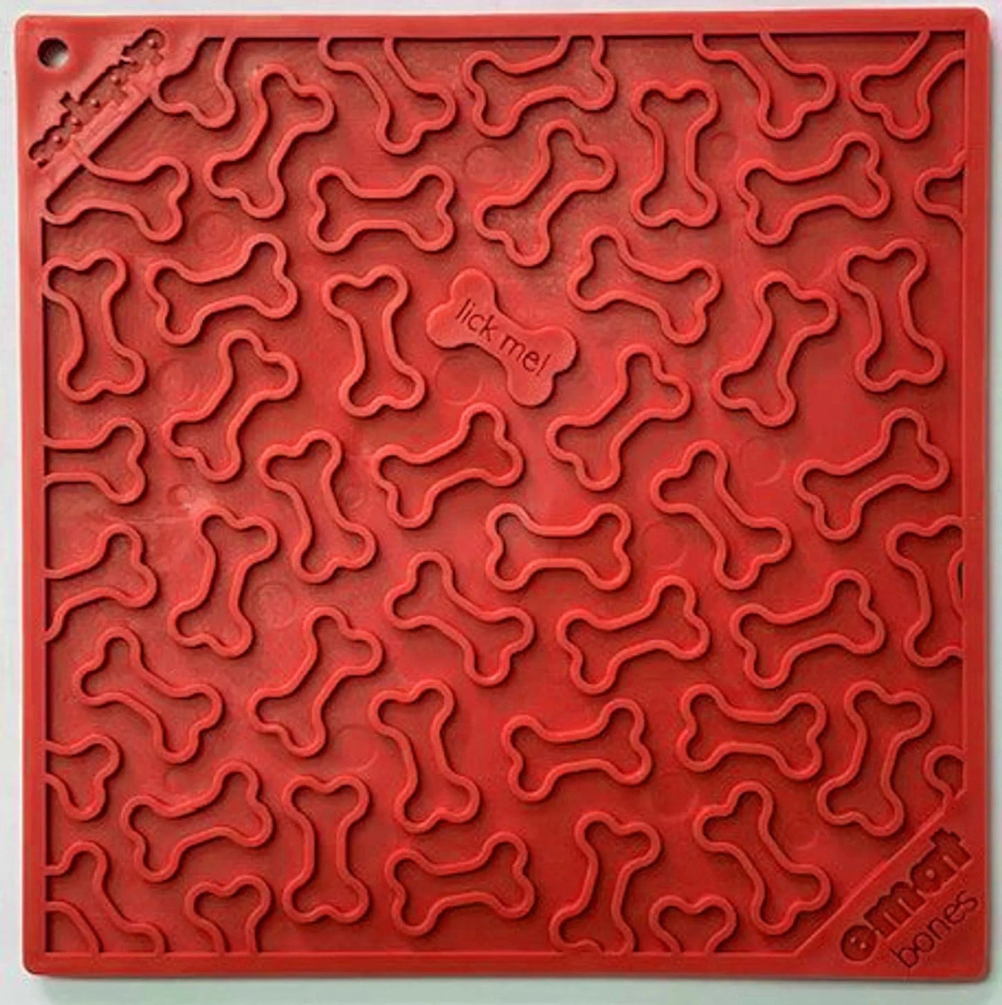 Red SodaPup Bones Design silicone lick mat with raised bone pattern