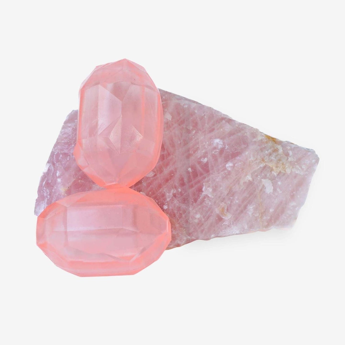 Set of two pink geometric enrichment chew toys on natural stone