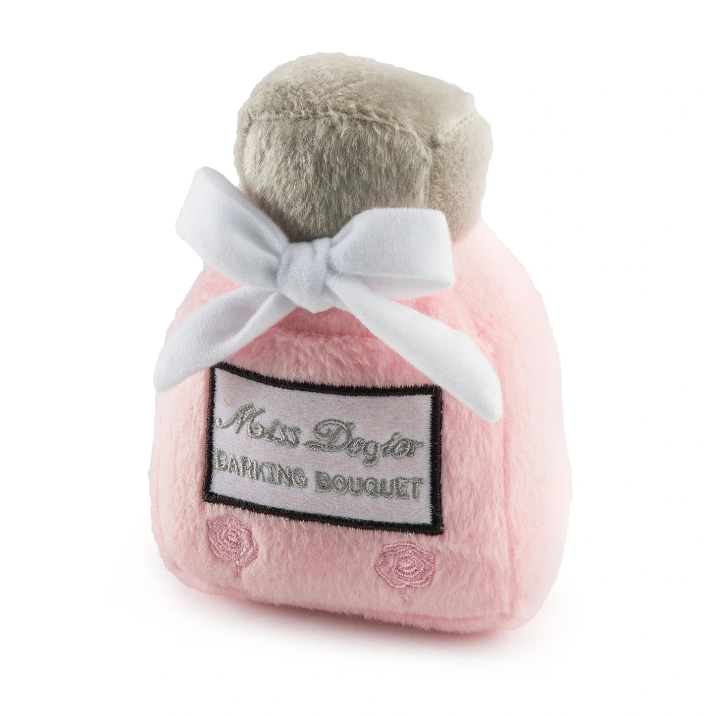 Pink Miss Dogior perfume bottle squeaker plush toy with beige cap, white bow, and embroidered rose details