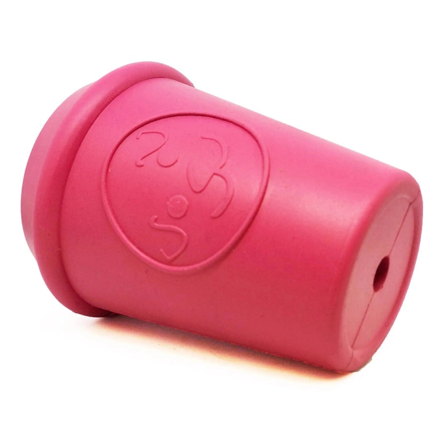 Pink coffee cup rubber treat dispenser lying on side showing bottom hole
