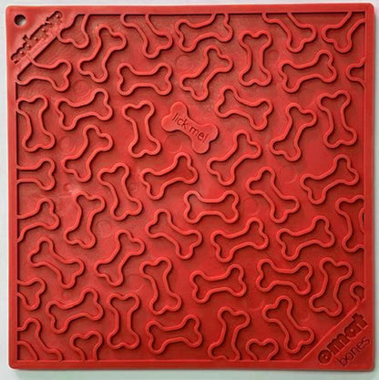 Red SodaPup Bones silicone lick mat with raised bone texture and 'lick me' center