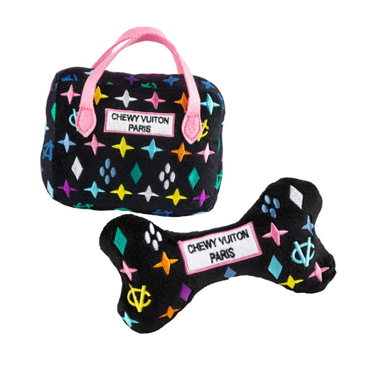 Chewy Vuiton Bundle squeaker plush toy with handbag and bone featuring pink handles and geometric patterns