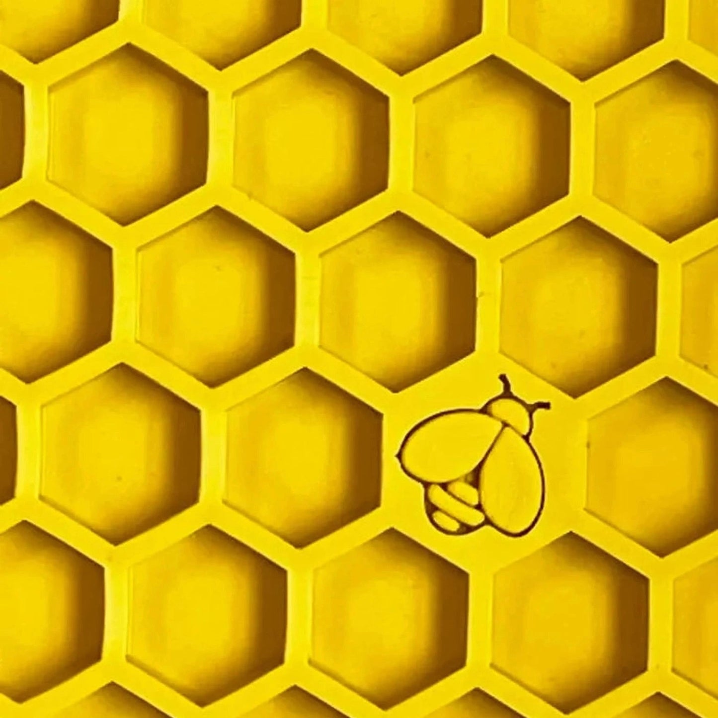 Close-up of deep hexagonal texture on yellow honeycomb lick mat