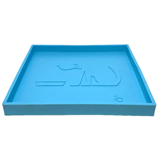 Orange circular slow feeder maze bowl on light blue rectangular suction cup base white background