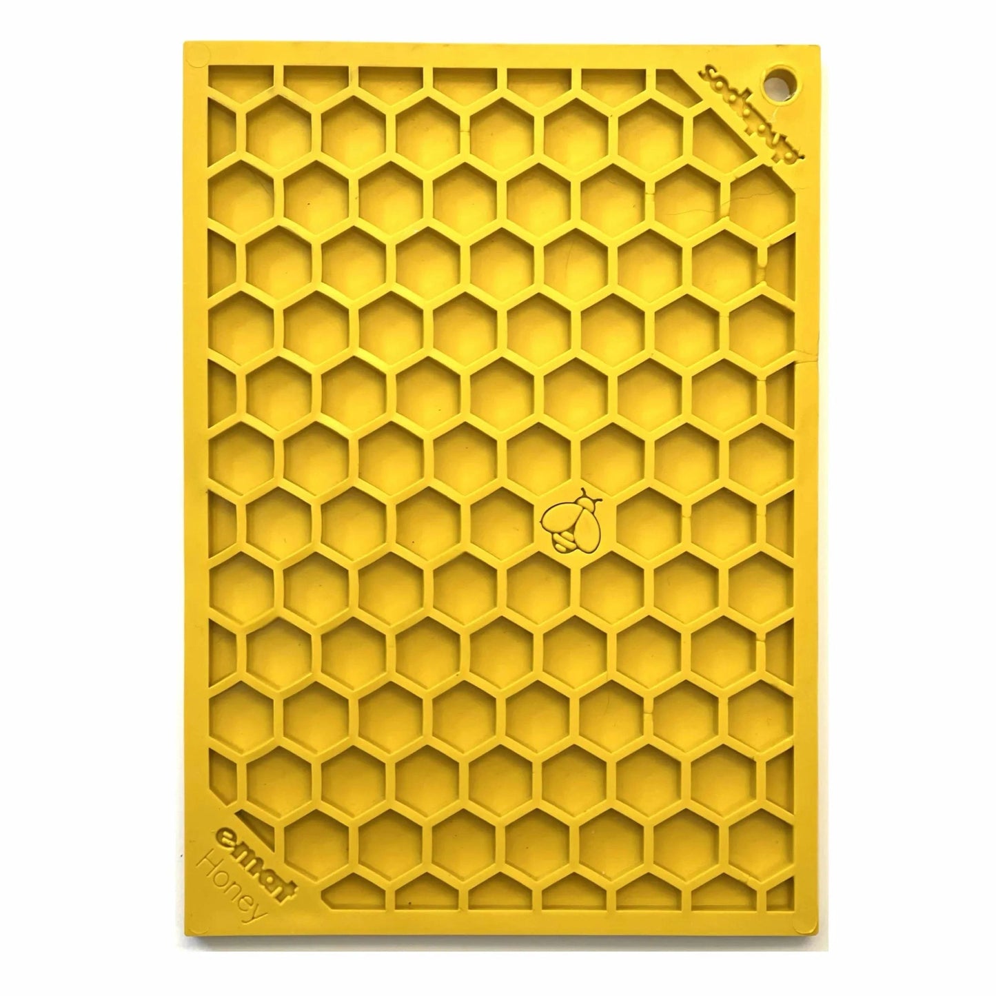 Yellow hexagonal cell lick mat standing upright showing texture