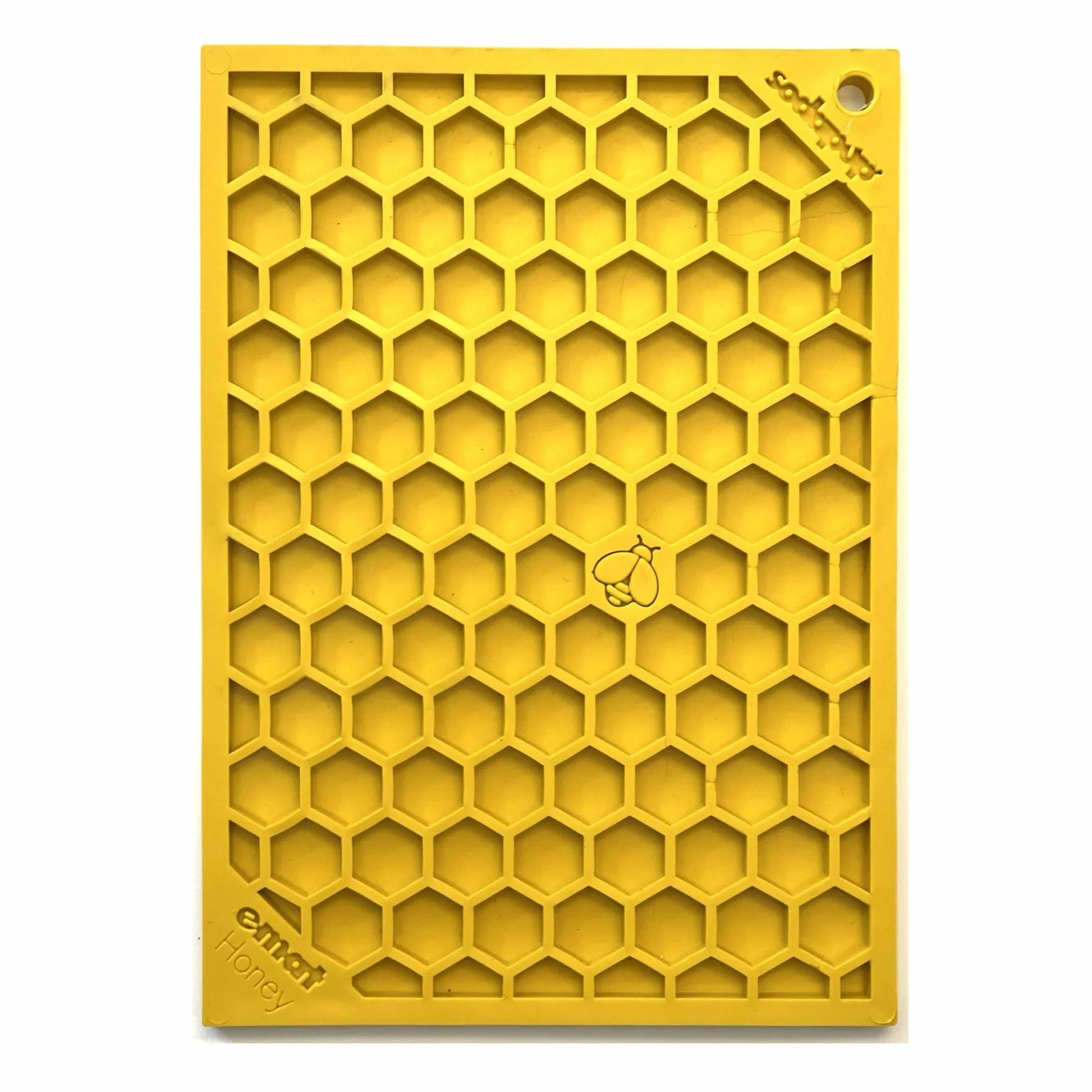 Yellow hexagonal cell lick mat standing upright showing texture