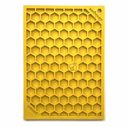 Yellow hexagonal cell lick mat standing upright showing texture