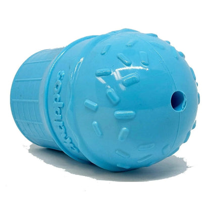 Side view of blue rubber dog toy showing circular treat opening and embossed brand logo
