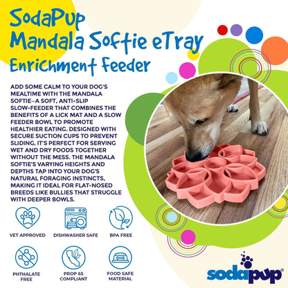 Tan dog eating from pink SodaPup Mandala Softie slow feeder lick mat on wooden floor