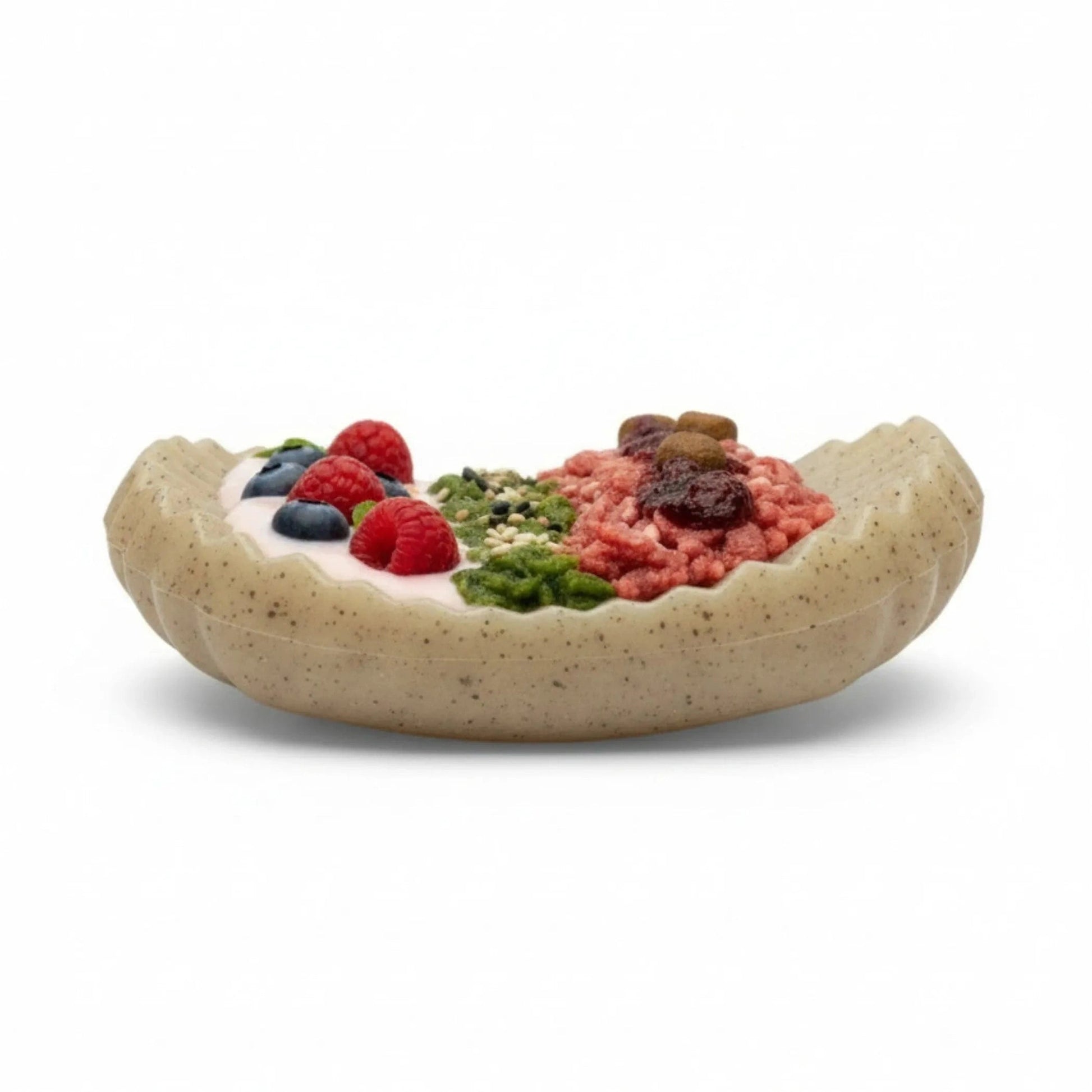 Side view of beige speckled nylon dog enrichment toy with food