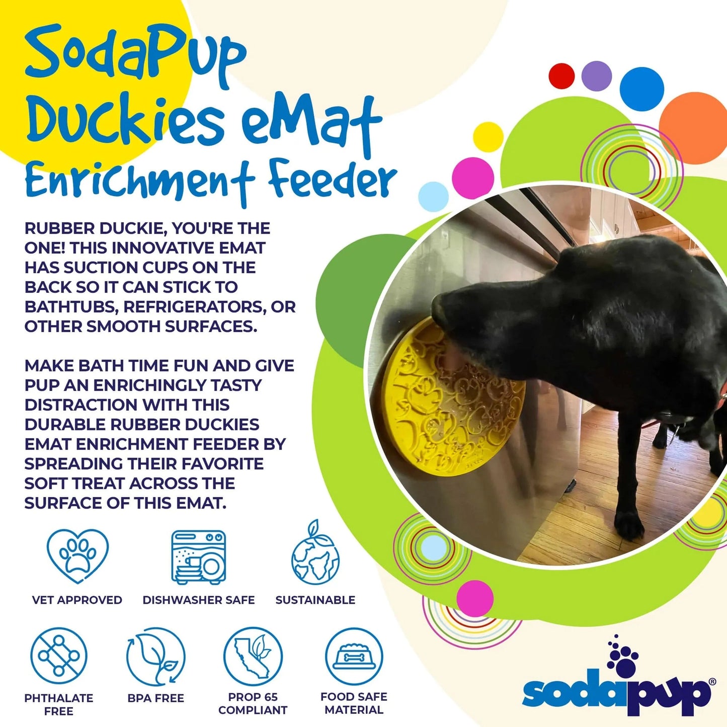 Black dog licking yellow duck pattern enrichment feeder on fridge