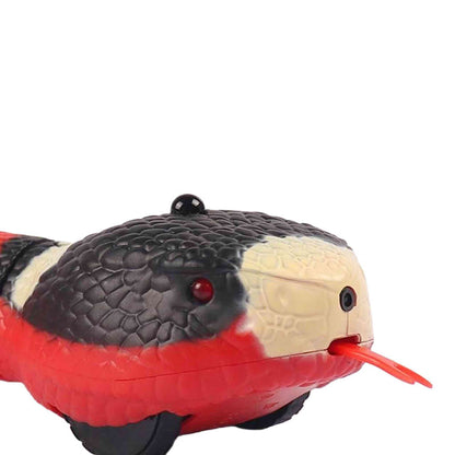 Close-up of robotic snake head with sensor button and red LED eye