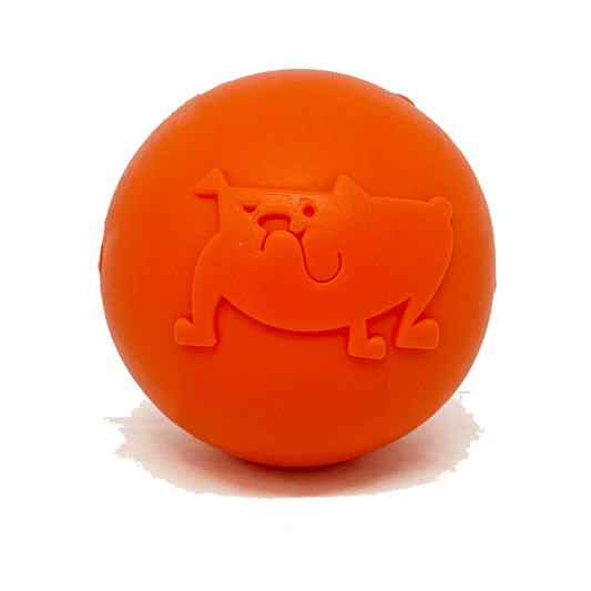 Orange embossed dog face rubber chew ball on white background