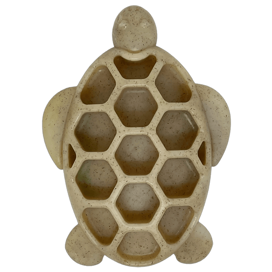 Beige speckled turtle puzzle feeder filled with dog treats and kibble for enrichment