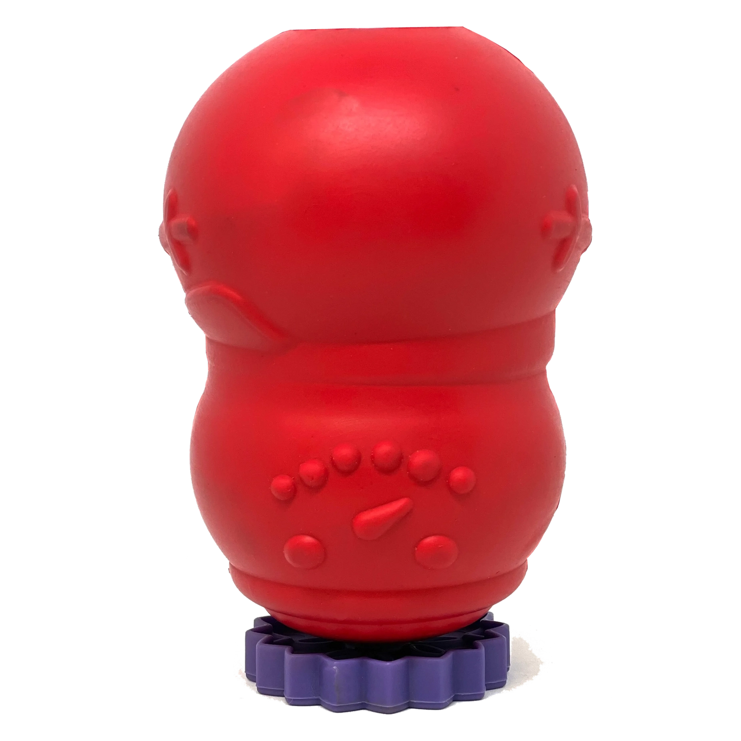 Red rubber dog toy standing upright on a purple flower-shaped SodaPup stopper stand to prevent messy liquid leaks during prep
